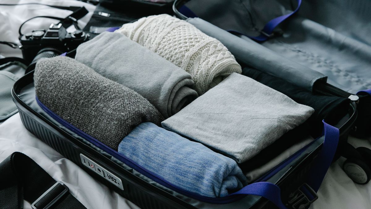 Folded clothes inside a travel suitcase.