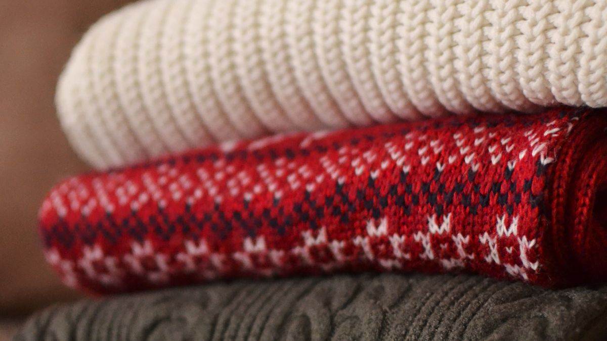 Folded patterned wool sweaters in a stack