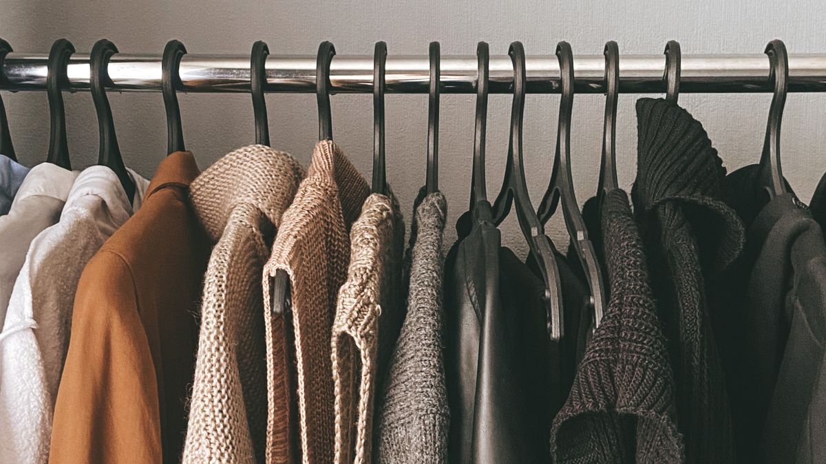 Knitwear and jackets hanging along a clothes rack