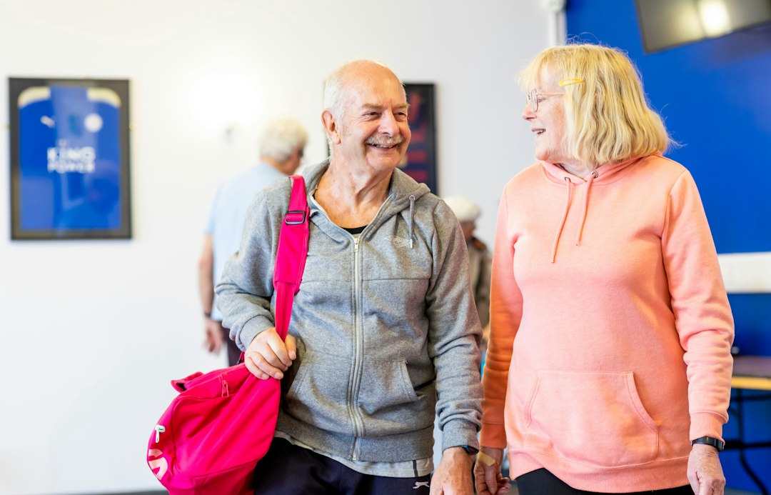 Older couple exercising together at a gym