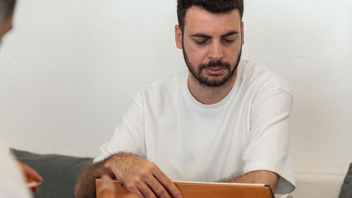 Men playing a tabletop game together in a home setting