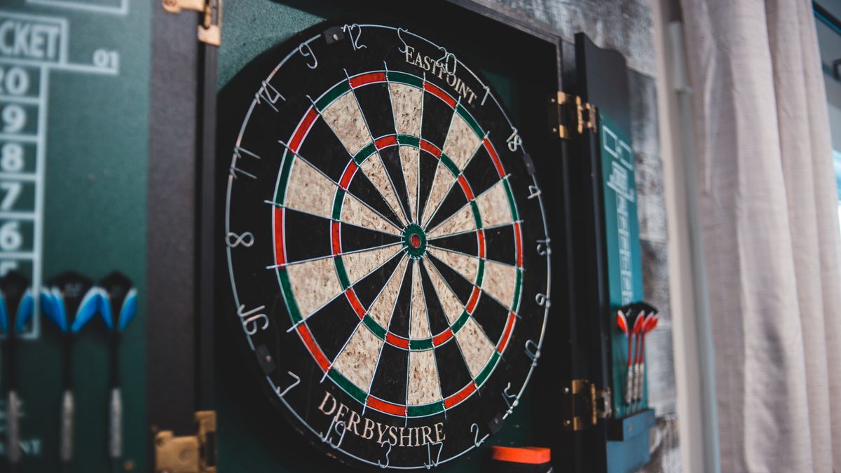 A dartboard fixed to an indoor wall