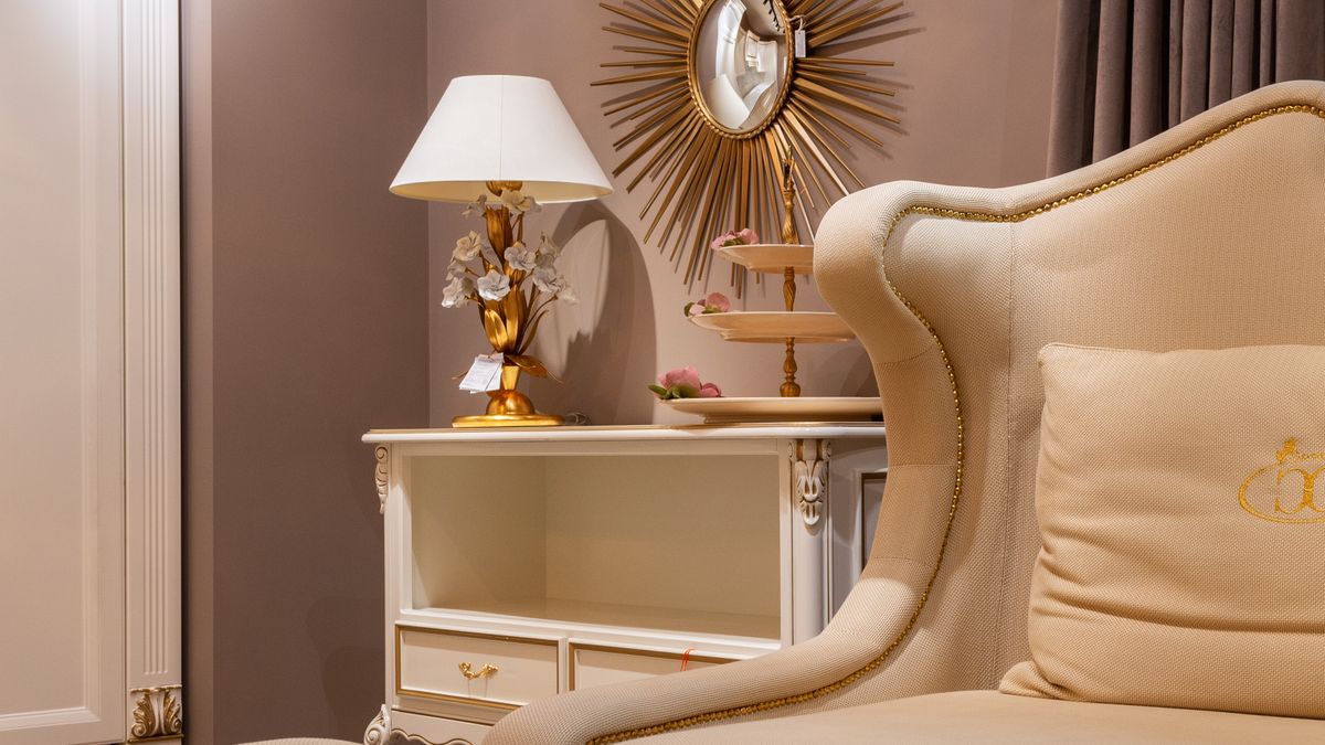 A folding beige sleeper sofa in a guest-ready lounge
