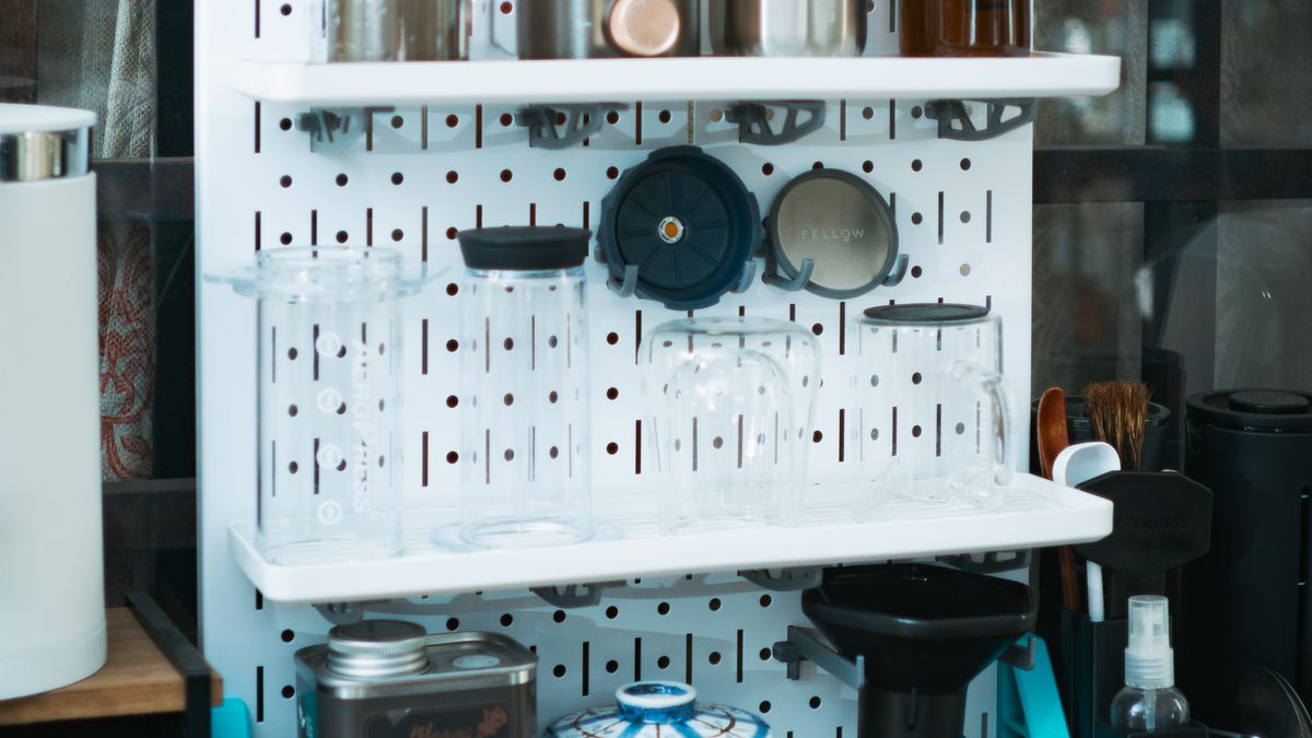 A compact coffee brewing station with neatly arranged accessories