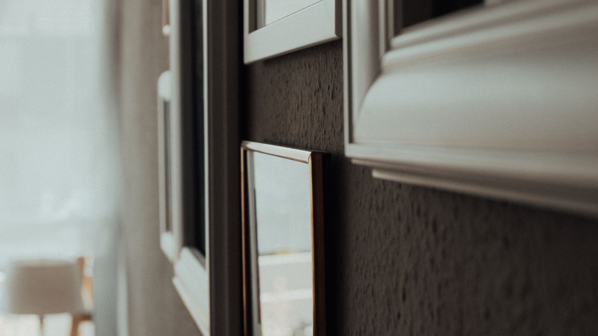 An arrangement of framed photographs forms a gallery wall