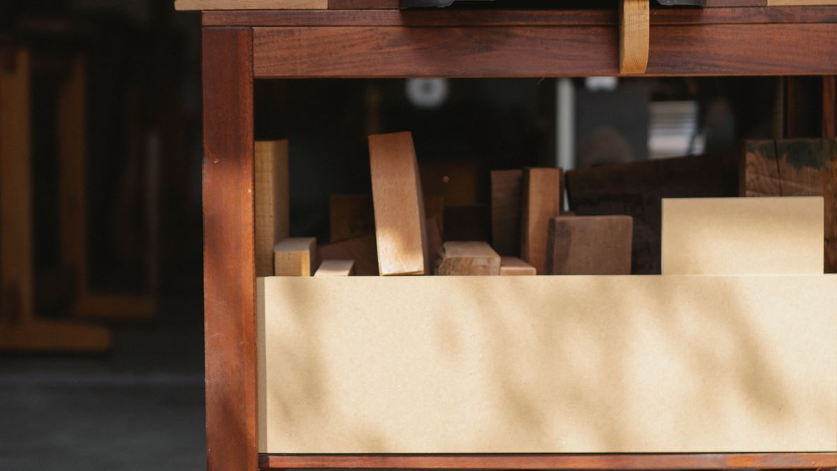 A wooden workbench and woodworking equipment in a workshop