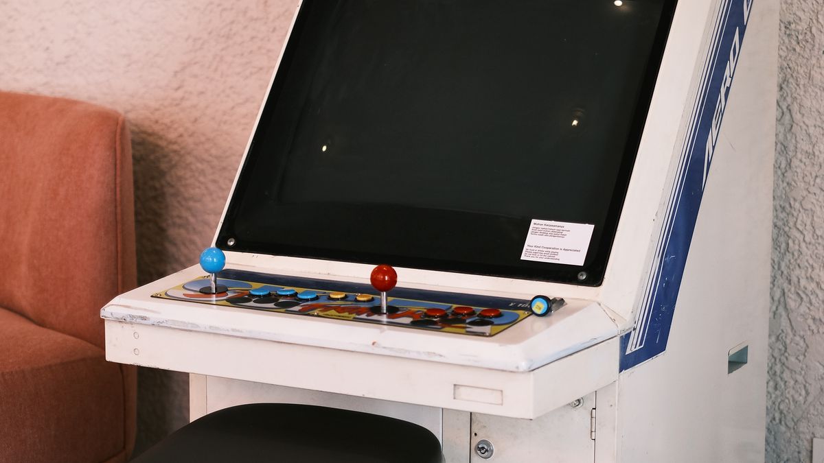 A single vintage arcade cabinet with joysticks and buttons