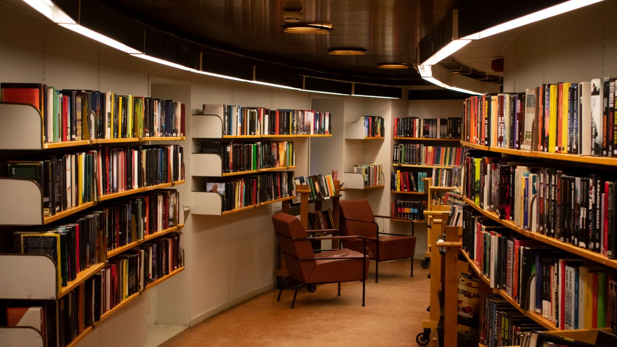 Leather seating beside wall-to-wall bookshelves