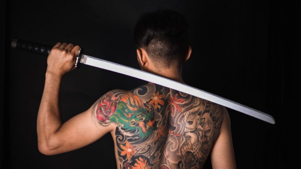 Back view of a tattooed man with a large back tattoo