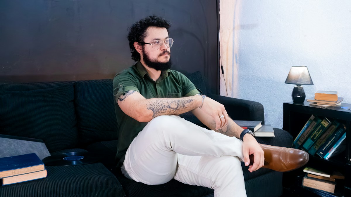 Man sitting at home with leg discomfort