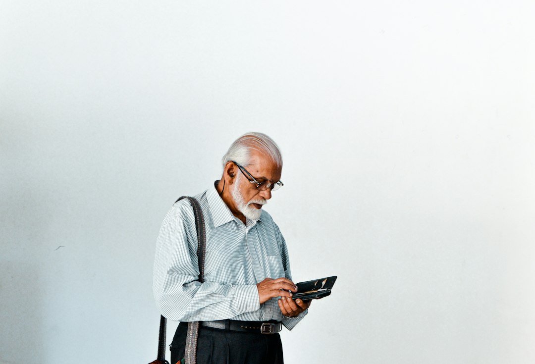 Older man using a tablet and reviewing information