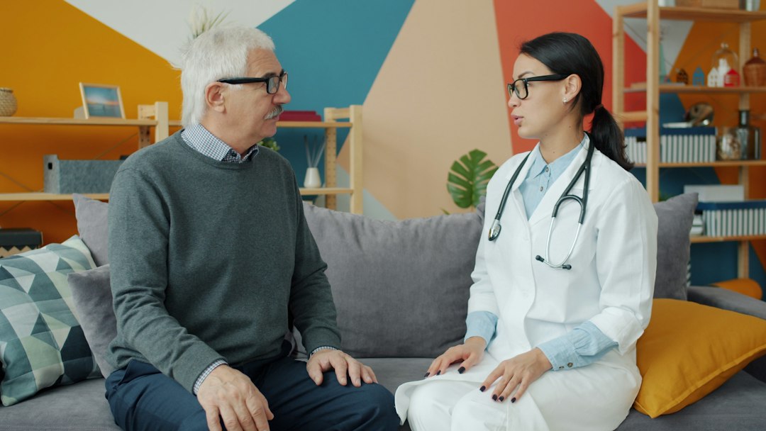 Older man speaking with a healthcare professional