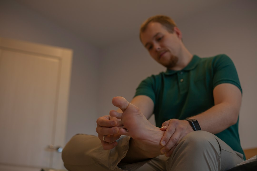 Man examining his foot as part of a foot care routine