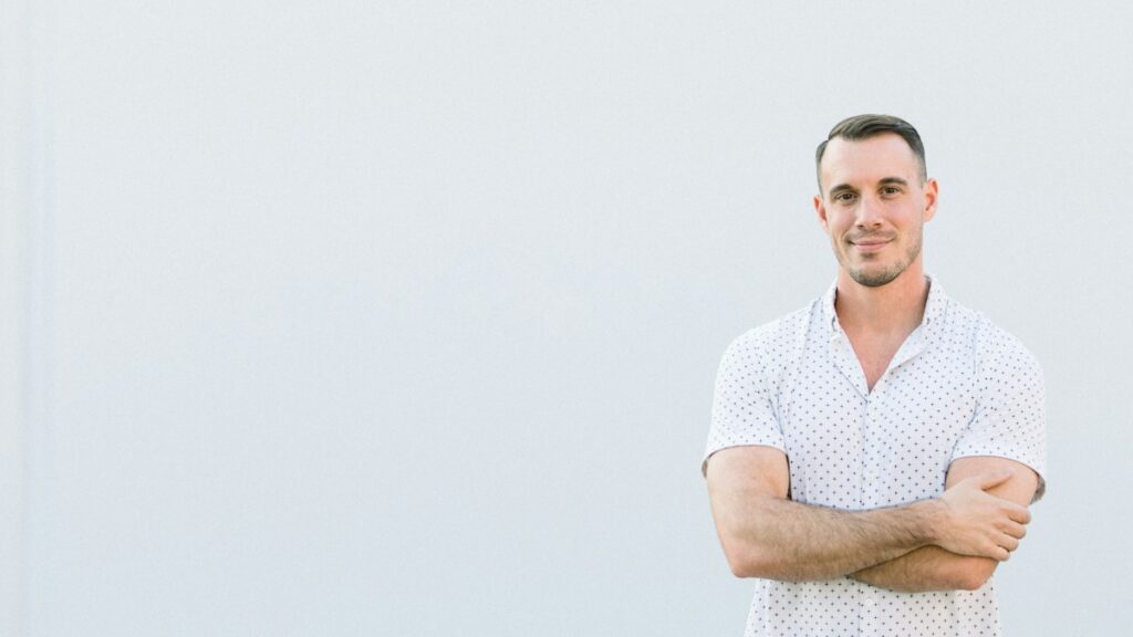 Confident man standing with his arms crossed