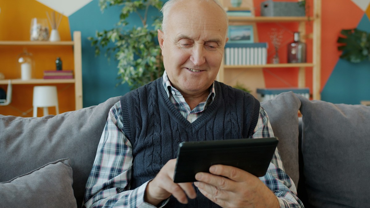 Senior man browsing a tablet