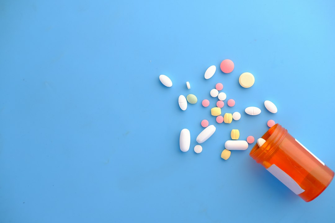 Prescription medication bottle and tablets