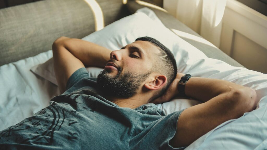 Man lying in bed at night