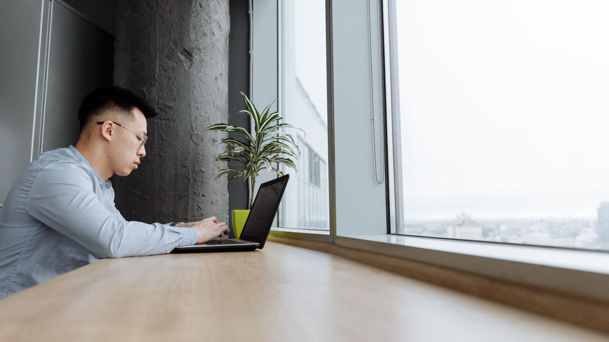 Professional using a laptop to test repeatable work instructions