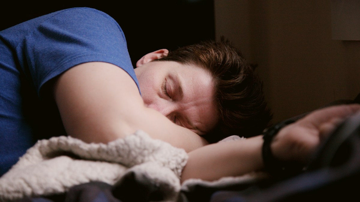 Man resting in bed at home