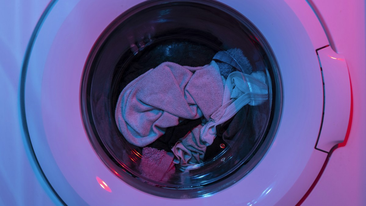 Washing machine illustrating laundering and care practices that affect clothing lifespan