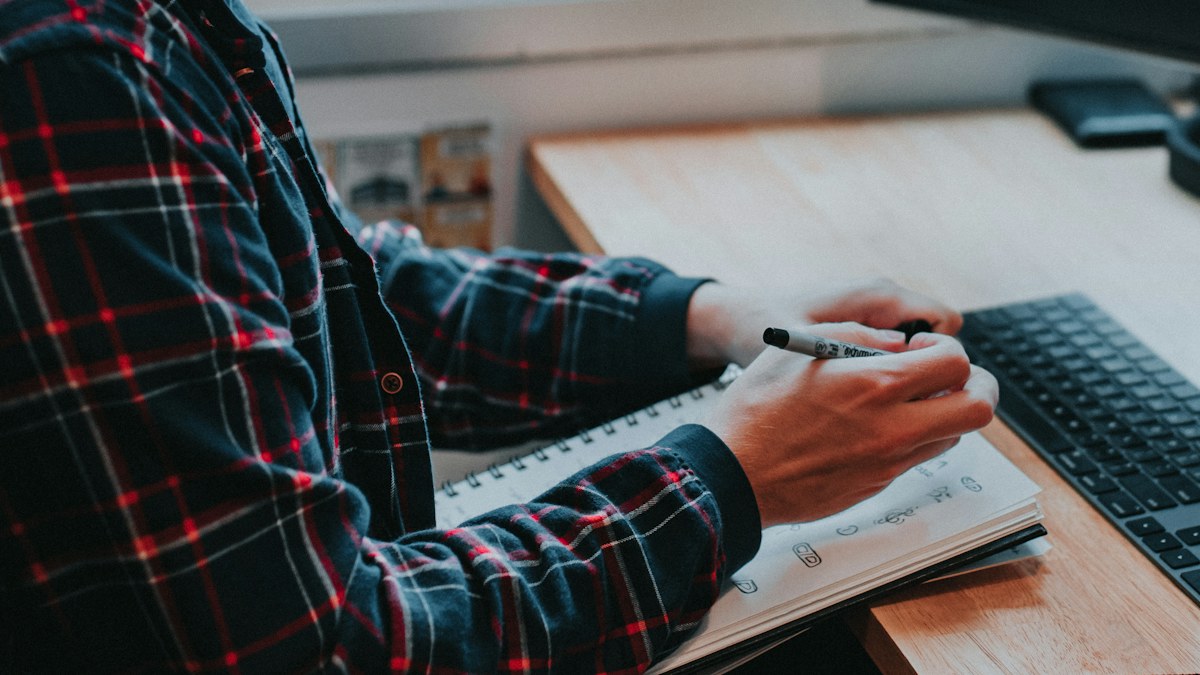 Man sketching and planning work at a desk