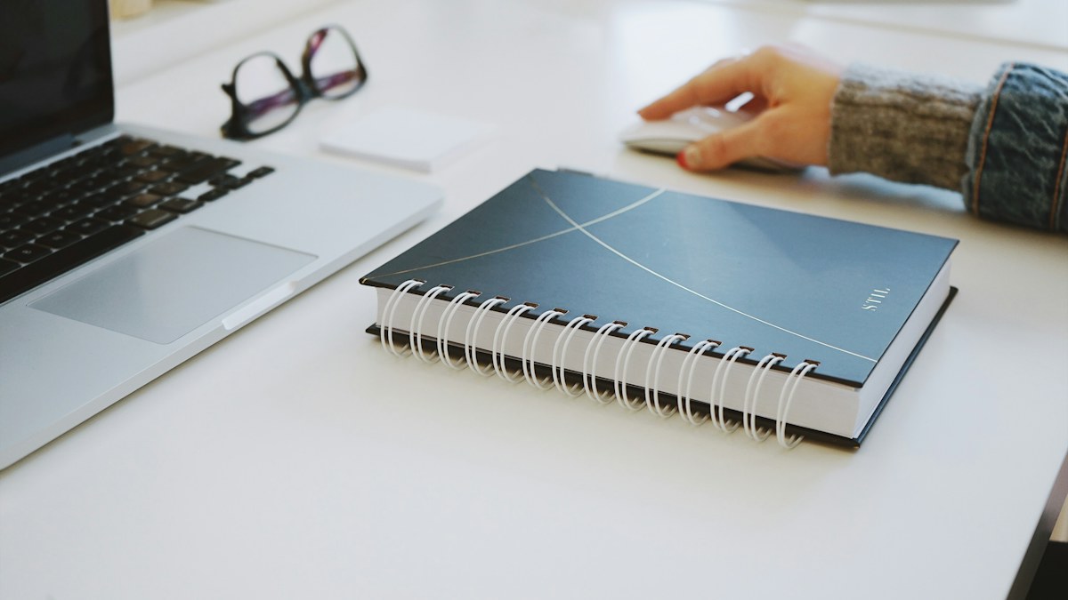 Laptop and notebook used during a weekly planning session