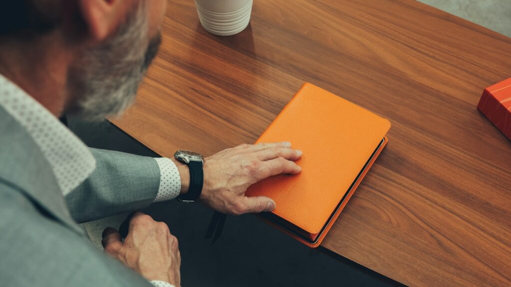Man planning his week with a notebook at a desk