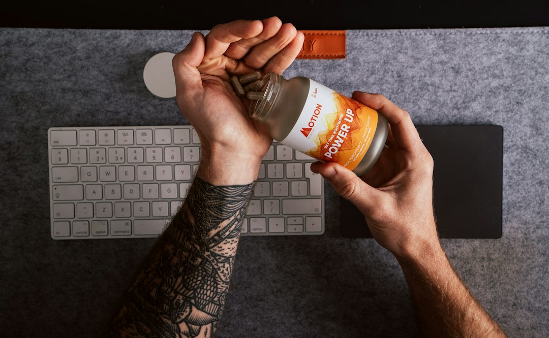 Person holding and reading a supplement bottle label